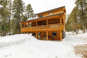 a log cabin in the woods in the snow at Aspen Glow Brand New Hot Tub in Duck Creek Village