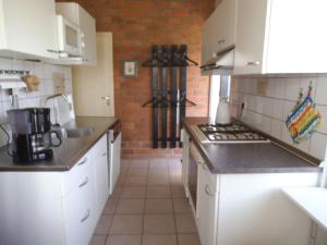 a kitchen with white appliances and a brick wall at Ferienhaus-Naumann-Kreetz in Burgerbrug