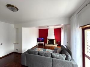 Una sala de estar con un sofá y una chimenea. en 3 Bedroom Apt 15 Min Walk to Fátima Sanctuary, en Fátima