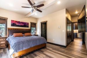 a bedroom with a bed and a ceiling fan at Good Karma Cabin - Luxury Mountain Retreat in Duck Creek Village