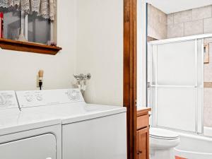 a white bathroom with a sink and a toilet at Cozy Bear Cabin in Duck Creek in Duck Creek Village +10 photos