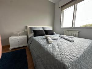 a bedroom with a large bed with two pillows at CASA Nieves in O Grove +20 photos