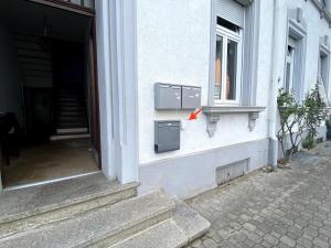 a box on the side of a building with a window at Basseltang urban apartment in Grenzach-Wyhlen