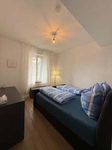 a bedroom with two beds and a ceiling at Basseltang urban apartment in Grenzach-Wyhlen