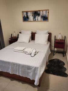 a bedroom with a bed with two white towels on it at Chez Nous in Pointe-Noire
