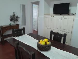 a dining room table with a basket of fruit on it at Casa Centro JH in La Rioja