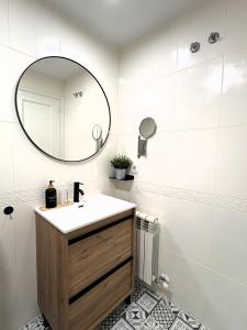 a bathroom with a sink and a mirror at EnBURELA Sol y Playa in Burela de Cabo +31 photos