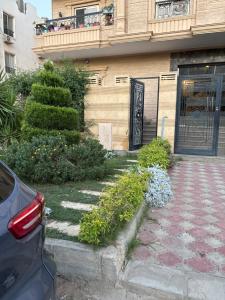 a building with a door and a balcony with flowers at Zayed hotel in Sheikh Zayed