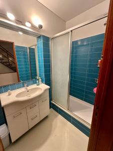 a bathroom with a sink and a shower at Casa Mareta in Sagres +20 photos