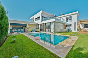 a large house with a swimming pool in the yard at Luxury Villa Heated Pool Taghazout Bay in Tamraght Ouzdar