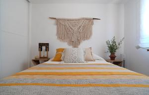 a bedroom with a bed with a blanket on it at GALIHOST - Casa Ría de Vigo in Redondela