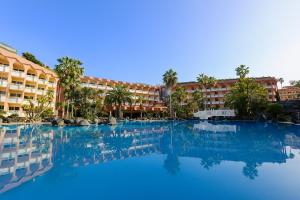 a large swimming pool in front of a hotel at Hotel Puerto Palace in Puerto de la Cruz