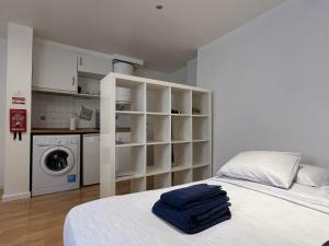 a bedroom with a white bed and a washing machine at Lisbon Life Alfama III in Lisbon
