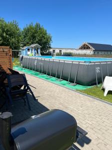 a large swimming pool with a water slide at Domki Arkadia Mielno in Mielno