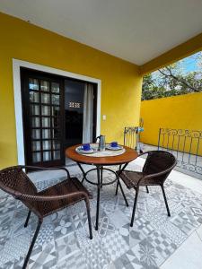 a table and two chairs on a patio at Toca Da Onça Suítes in Lençóis