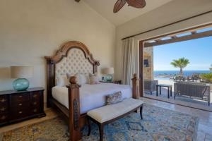 a bedroom with a bed and a view of the ocean at Ocean & Desert Hacienda Charm Villa in San José del Cabo +85 photos