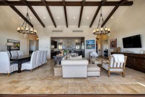 a living room with white chairs and a dining room at Ocean & Desert Hacienda Charm Villa in San José del Cabo