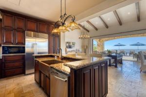 a large kitchen with a sink and a counter top at Ocean & Desert Hacienda Charm Villa in San José del Cabo