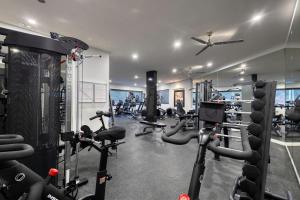 a gym with several treadmills and exercise bikes at New 3 BD Condo with Pool and Gym in Cabo San Lucas