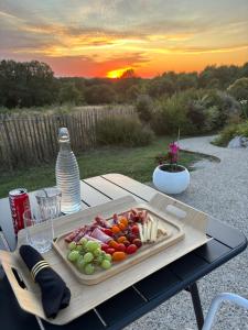 a tray of food on a table with a plate of food at Le Coucher de Soleil Spa in Bessens
