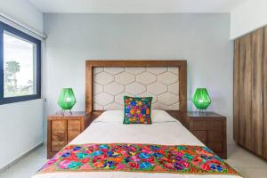 a bedroom with a large bed and two lamps at 2BD Condo with Roof shared Pool in Cruz de Huanacaxtle +16 photos