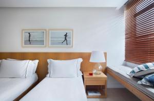Кровать или кровати в номере JANEIRO Hotel