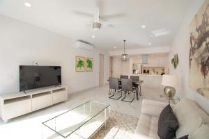 a living room with a couch and a tv at AMATERRA modernos aptos cerca a la playa in Cabo San Lucas