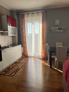 a kitchen with a table and a dining room at casa mioara in Montefiascone +2 photos