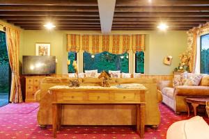 a living room with a couch and a table at Countryside Retreat with On-site Horse Experiences in Waikopua