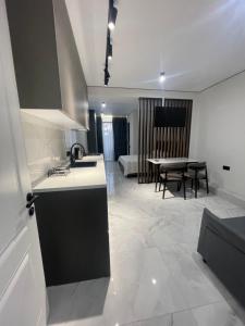 a kitchen and a living room with a table at Nika house in Ureki