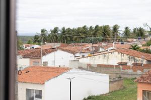 a view of a city with buildings and palm trees at Pousada Gonçalves in Tangará