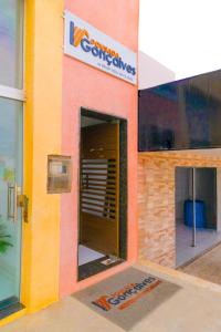 a building with a sign on the side of it at Pousada Gonçalves in Tangará +15 photos