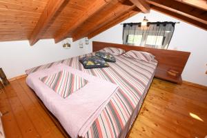 a bed with two pillows on it in a bedroom at Country house Speri in Samos