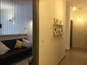 a living room with a black couch and a book shelf at SulMare Alba Adriatica in Alba Adriatica