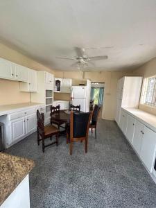 a kitchen with a table and chairs and a refrigerator at Harbor View Estates in Castries