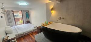 a bathroom with a large bath tub and a bed at Bu House Hanoi Old Quarter in Hanoi +32 photos