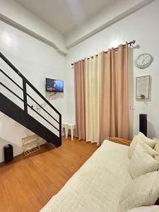 a bedroom with a bed and a tv in it at Condo in Baguio - Megatower 3 - Near SM in Baguio