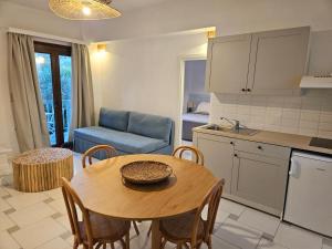a kitchen and a dining room with a table and a couch at Paralies Resort in Skiathos Town