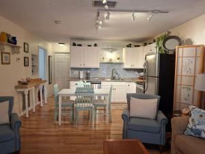 a kitchen with white cabinets and a table and chairs at The Three Sisters - Pelican Crystal River FL in Crystal River