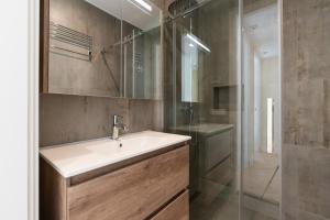 a bathroom with a sink and a shower at Park Central Executive Apartments 102 in The Hague +33 photos