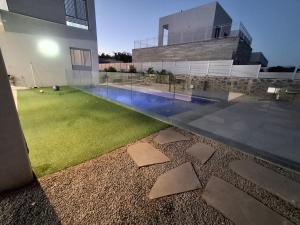 a house with a yard with a swimming pool at סוויטת בארי , שלווה בגליל העליון in Mishmār Hāyardin
