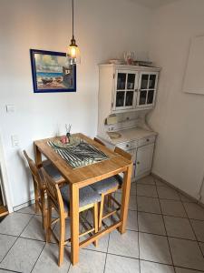 a kitchen with a wooden table and chairs at Basseltang urban apartment in Grenzach-Wyhlen