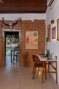a room with a table with a laptop on it at Comfort in the center of Piri - Casa Ipê Branco in Pirenópolis