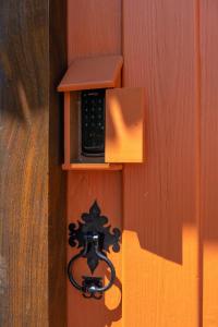 a wooden box with a phone on a wall at Comfort in the center of Piri - Casa Ipê Branco in Pirenópolis