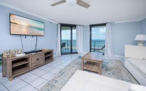 a living room with a flat screen tv and a couch at Phoenix IV 4053 condo in Orange Beach