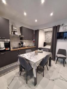 a kitchen and dining room with a table and chairs at Stella Mare 2 in Santa Flavia