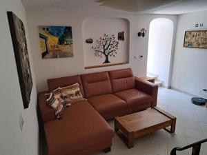 a living room with a brown couch and a table at Apartment Greta in Funtana