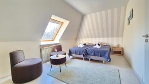 a bedroom with a bed and a chair at VILLA CASSIA w Rabce przy Parku Zdrojowym - smaczne śniadania i obiady in Rabka-Zdrój