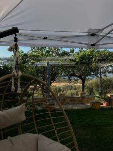 a swing under a white umbrella in a yard at Boho Escape - Jacuzzi & Sea View in Eretria