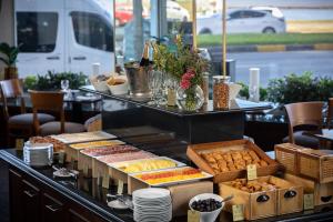 a buffet line with different types of bread and pastries at Cala di Volpe Boutique Hotel in Montevideo